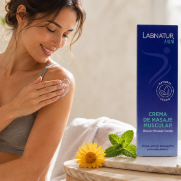 Persona aplicando Crema de Masaje Muscular Labnatur Fisio en el brazo junto el envase del producto y sus ingredientes naturales.